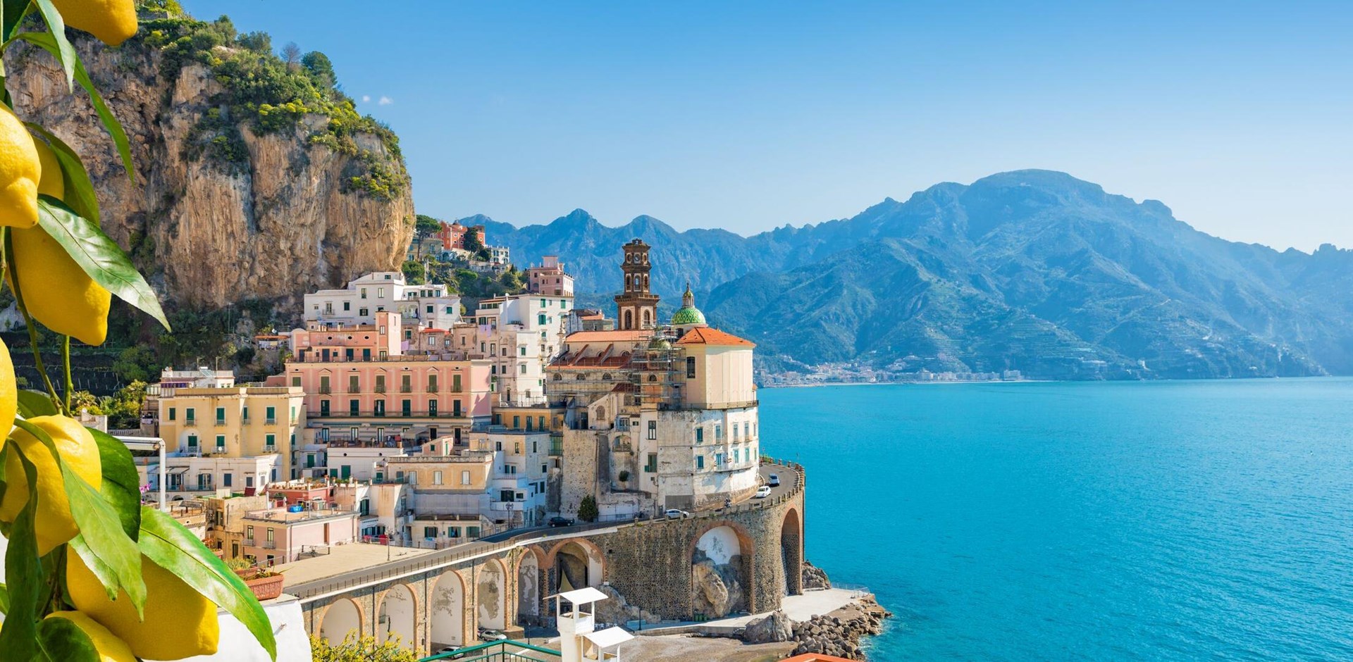 Small city Atrani on Amalfi Coast in province of Salerno, Campania region, Italy. Amalfi coast on Gulf of Salerno is popular travel and holyday destination in Italy. Ripe yellow lemons in foreground.