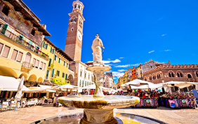 Piazza delle erbe in Verona street and market view with Lamberti tower, tourist destination in Veneto region of Italy