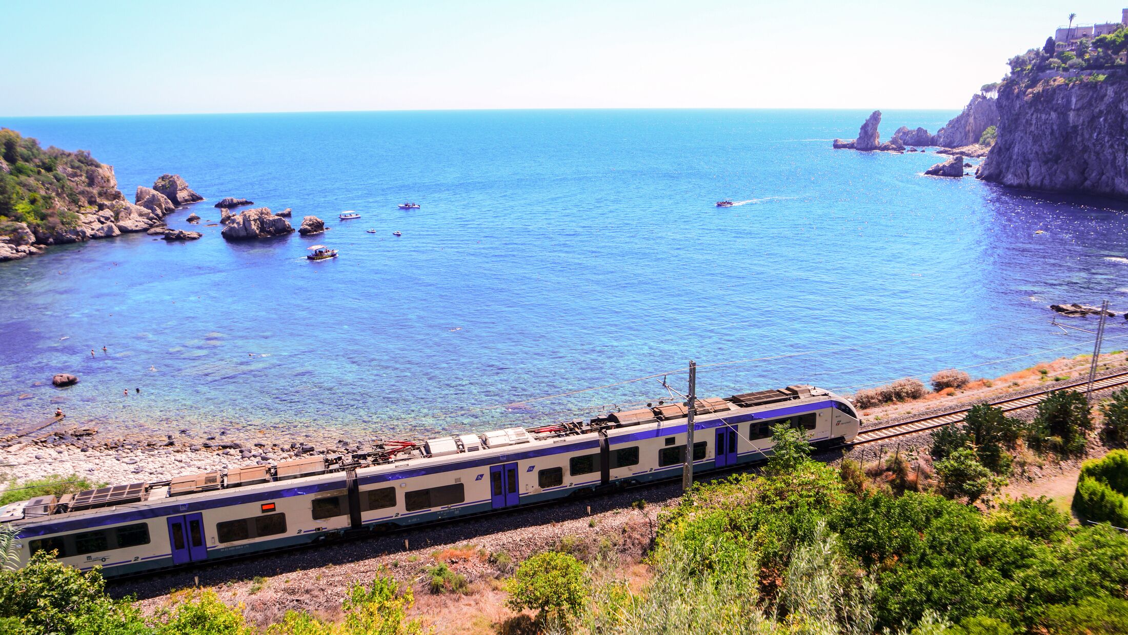 ocean with train alongside the coast Taormina Sicily Italy September 2016