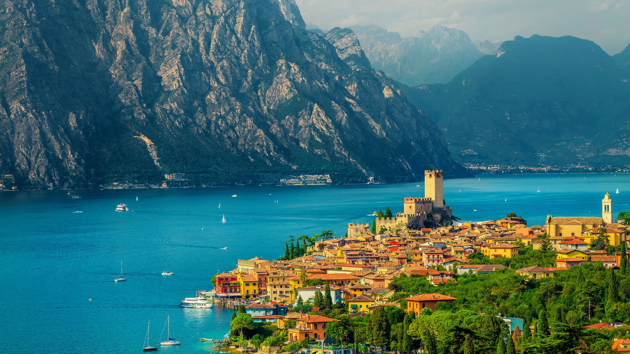 Fantastic summer vacation place, beautiful Malcesine mediterranean cityscape with colorful buildings view from the hill, lake Garda, Italy, Europe