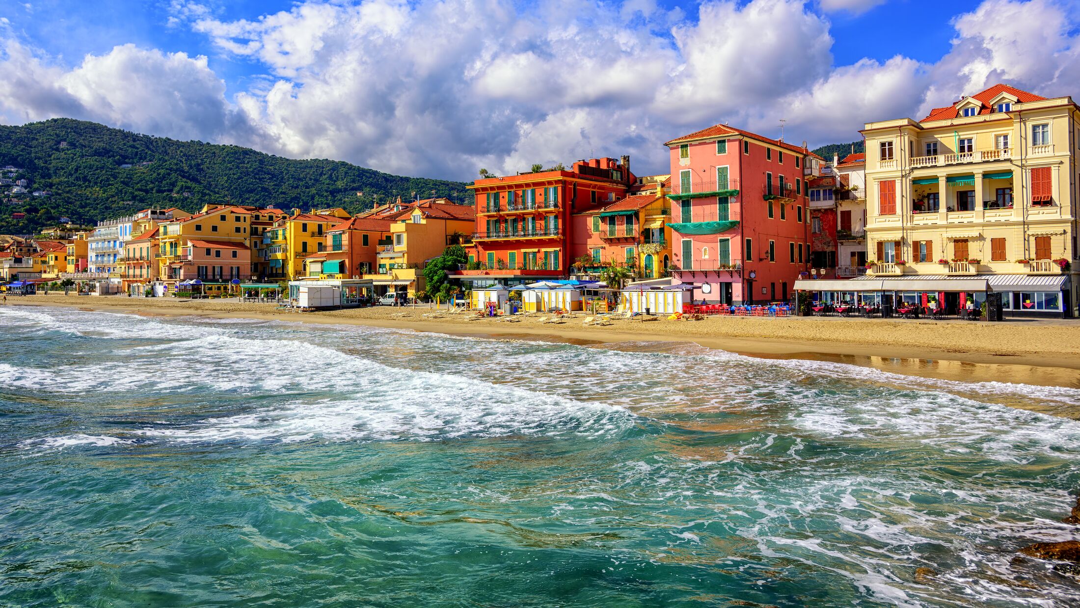 Mediterranean sand beach in traditional touristic town Alassio on italian Riviera by San Remo, Liguria, Italy