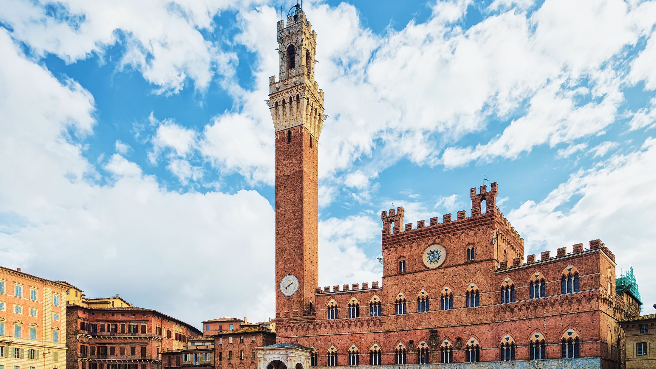 People at Torre del Magnia Tower on Piazza Campo Square in Siena, Tuscany, Italy