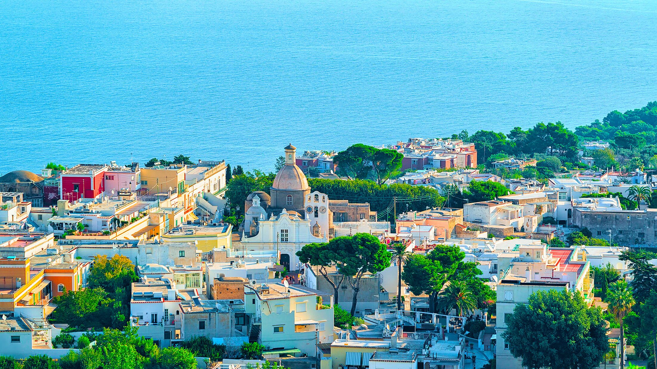 View with villas architecture on Capri Island at Naples in Italy. Landscape with boats and yachts at Mediterranean Sea at Italian coast. Anacapri in Europe on summer. Amalfi scenery on Solaro mountain