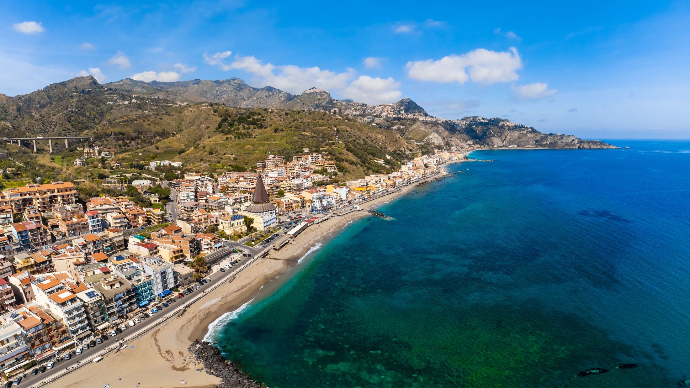 View with Giardini Naxos and Taormina, Sicily. Beach and sea in summer
