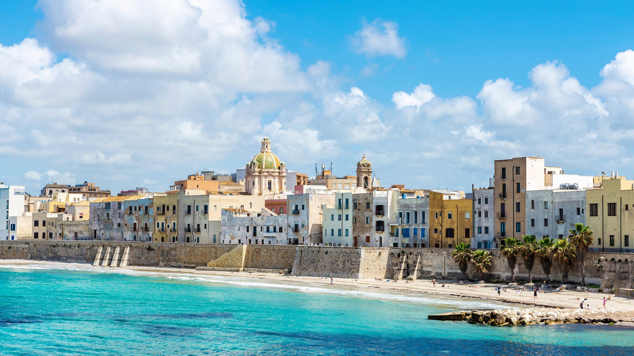 Promenade and beach with people around in the old town of Marsala, Trapani, Sicily, Italy