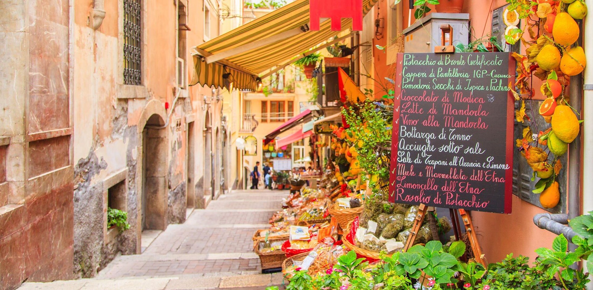 Entrance to local shop in Taormina, Sicily. Writing on the black table lists itmes on promotion.