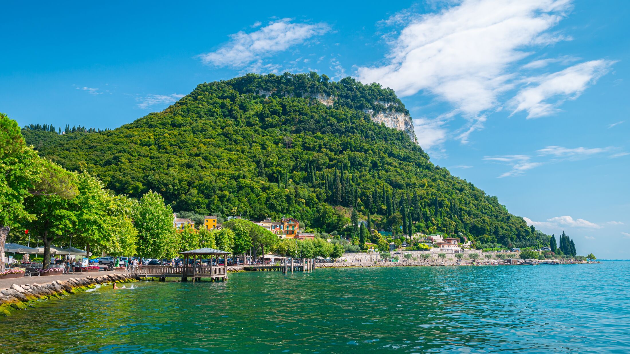 Picturesque view of the shore of Lake Garda, Italy in the place Garda with its characteristic mountain ¨Rocca di Garda¨.