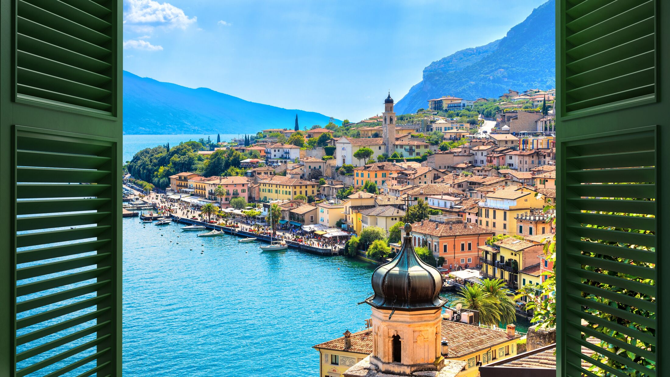 Window overlooking the village Limone Sul Garda on Garda Lake. The most famous tourist destination on lake. Lombardy, Italy.