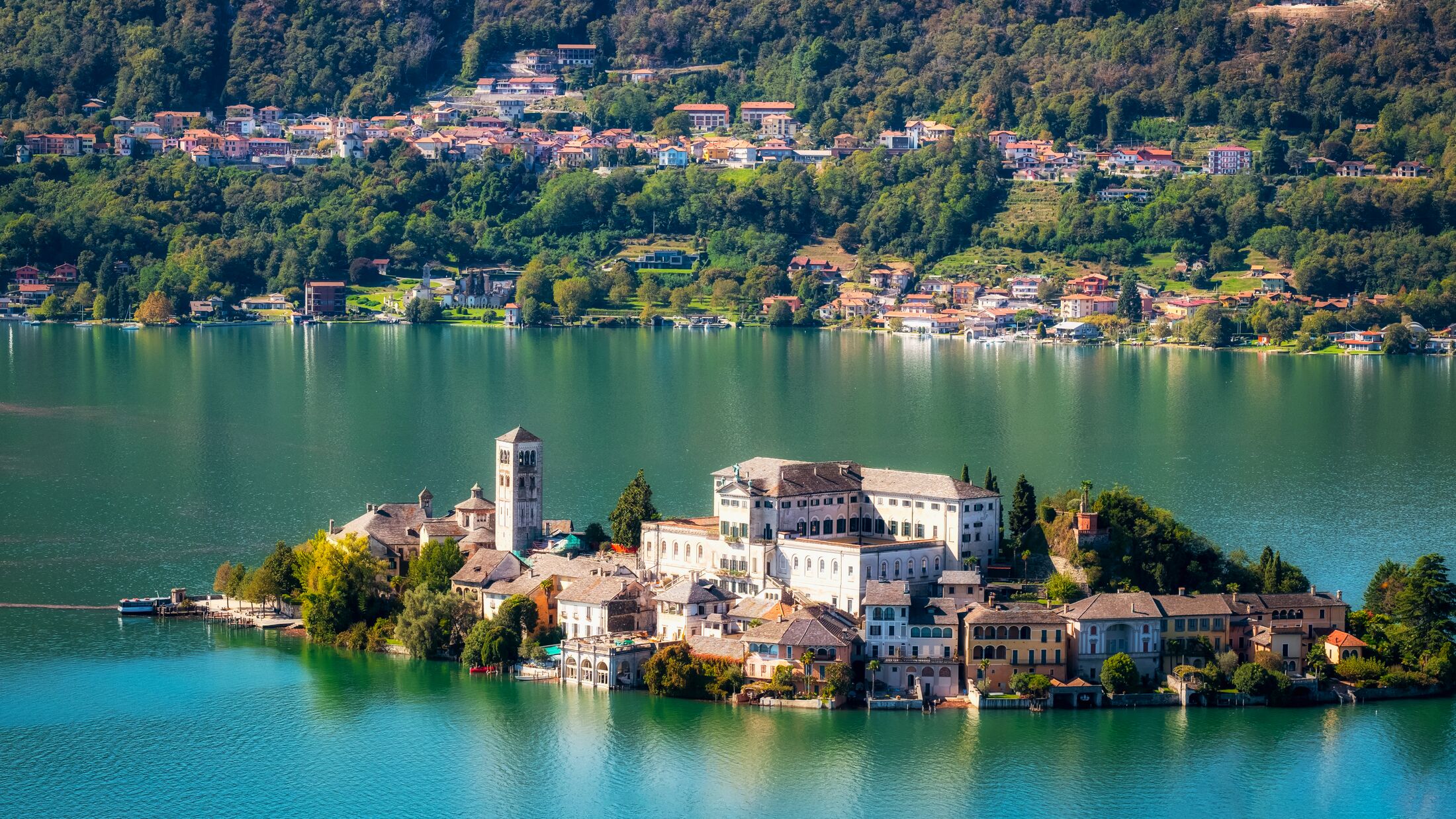The world famous Orta San Giulio island, in the Orta Lake (piedmont, Northern Italy) seen from the top of Sacro Monte di Orta. UNESCO World Heritage Site, it is home to a convent of cloistered nuns.
