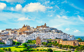 Ostuni white town skyline at sunset, Brindisi, Apulia southern Italy. Europe.