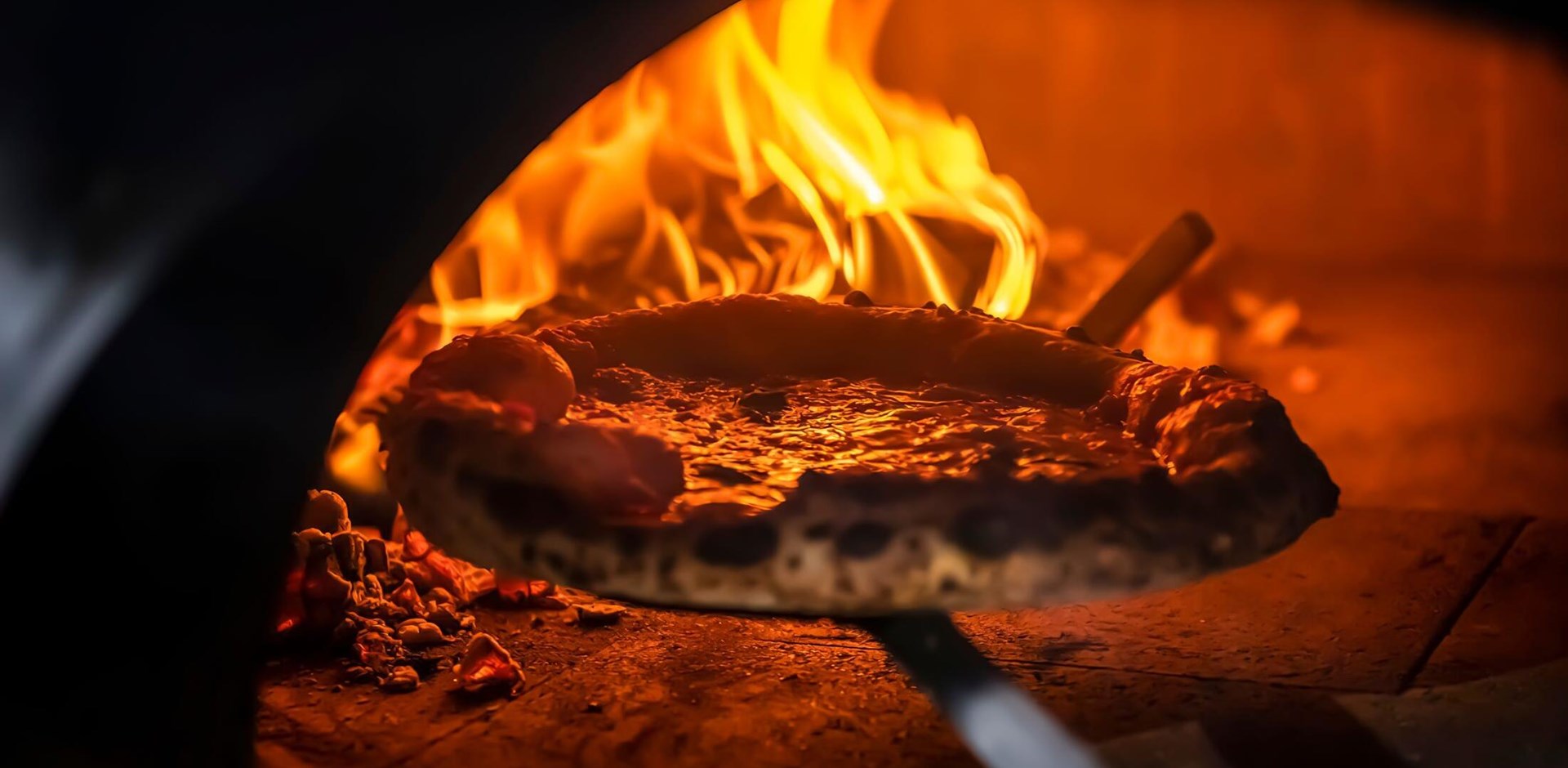 Pizza Margherita (Neapolitan pizza) straight from a wood-fired oven. Close-up, baked in a wood-fired pizza oven. Macro. Interior. Italian cuisine.