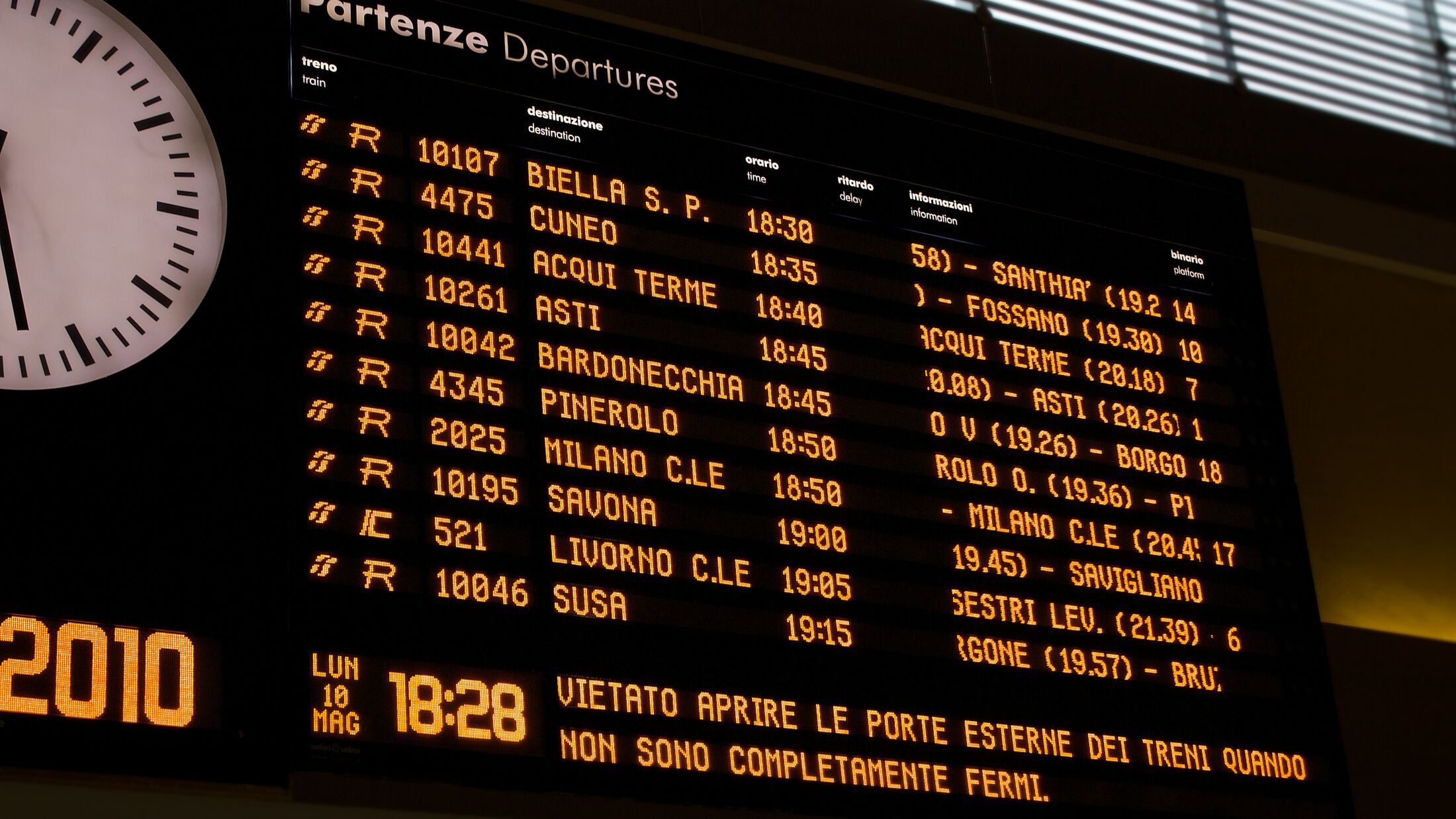 Timetables display in italian rail station with arrival and departure time