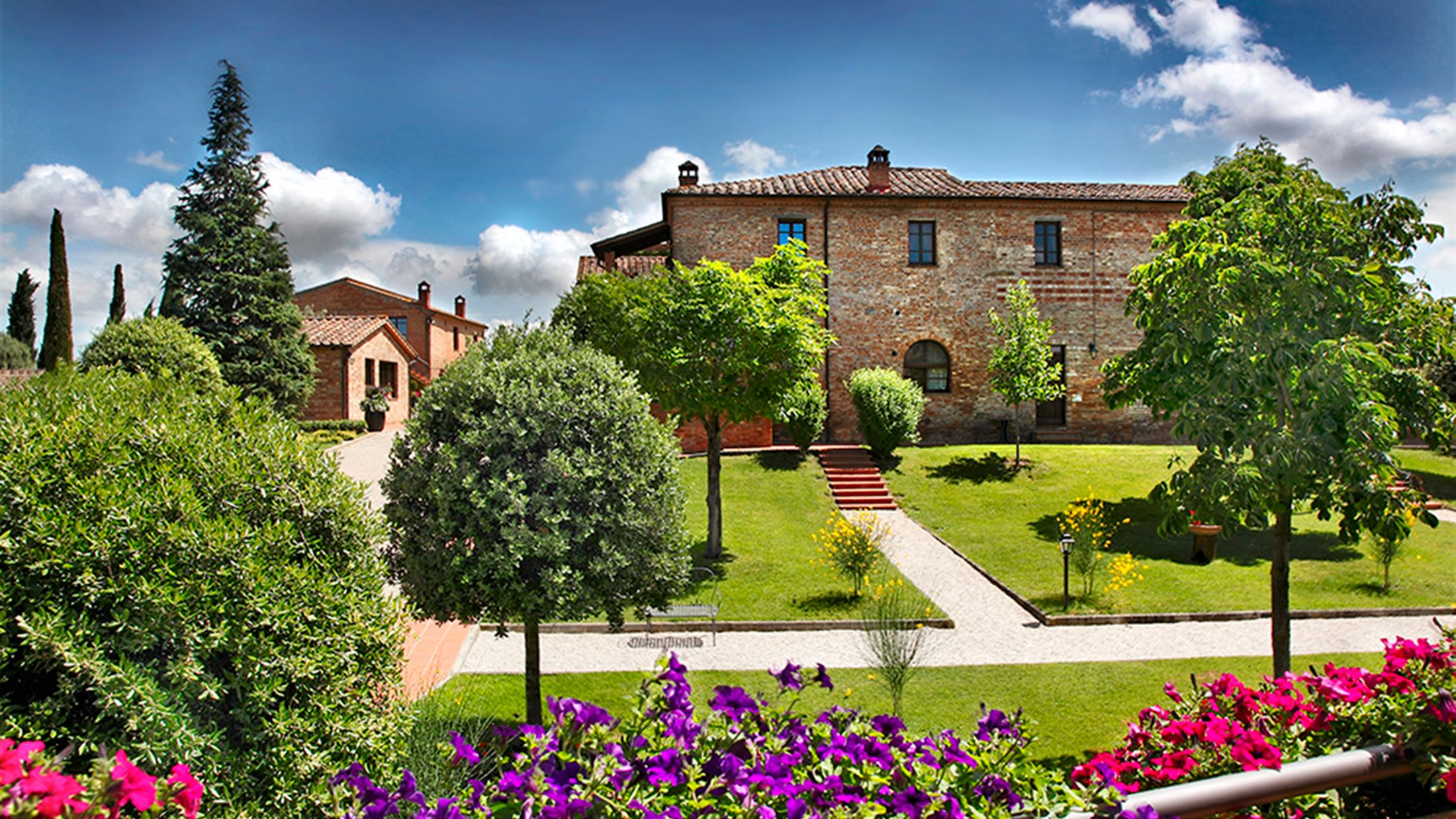 a close up of a flower garden in front of a house