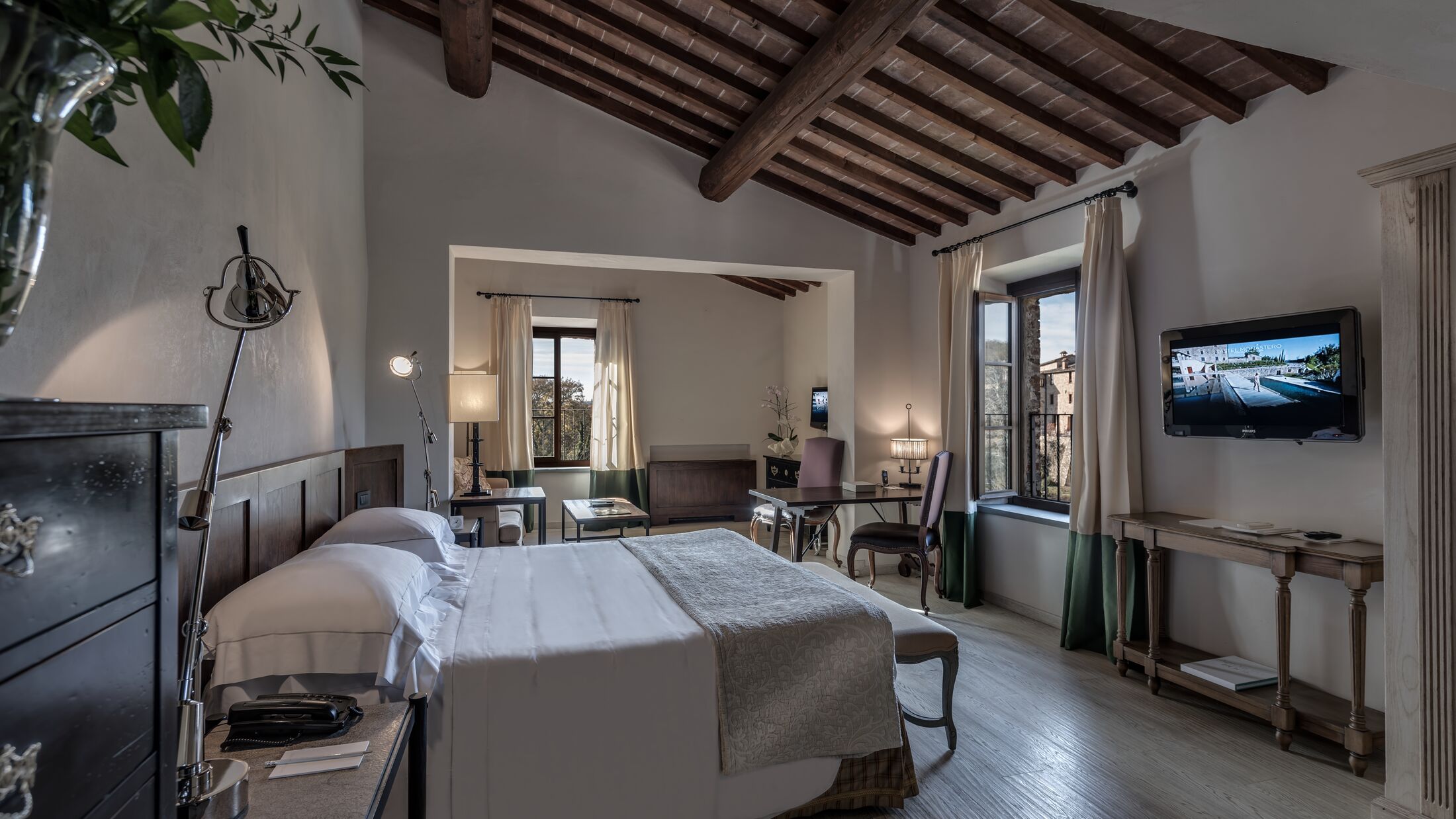 a bedroom with a bed and a mirror in a room