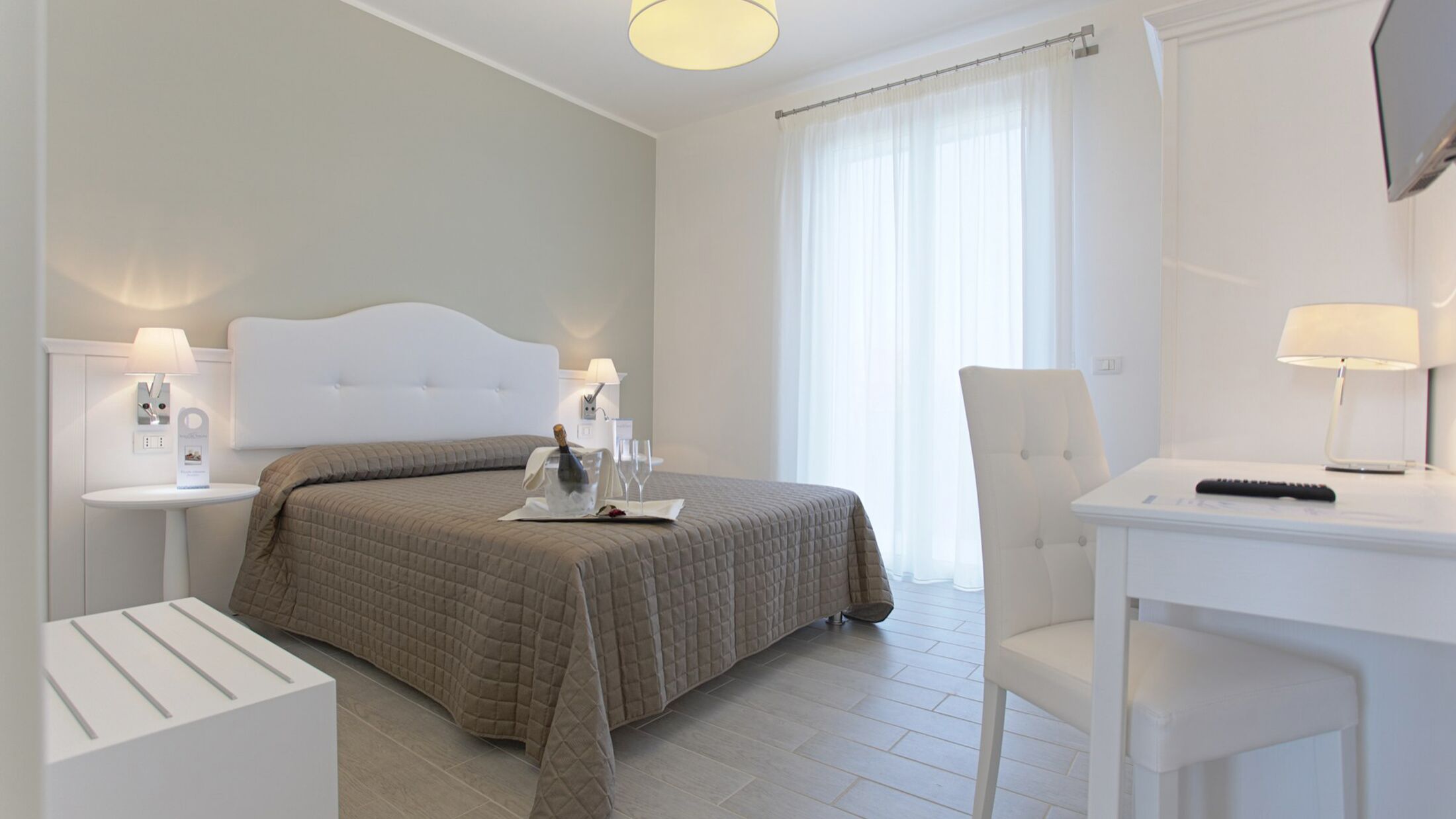 a bedroom with a bed and desk in a room