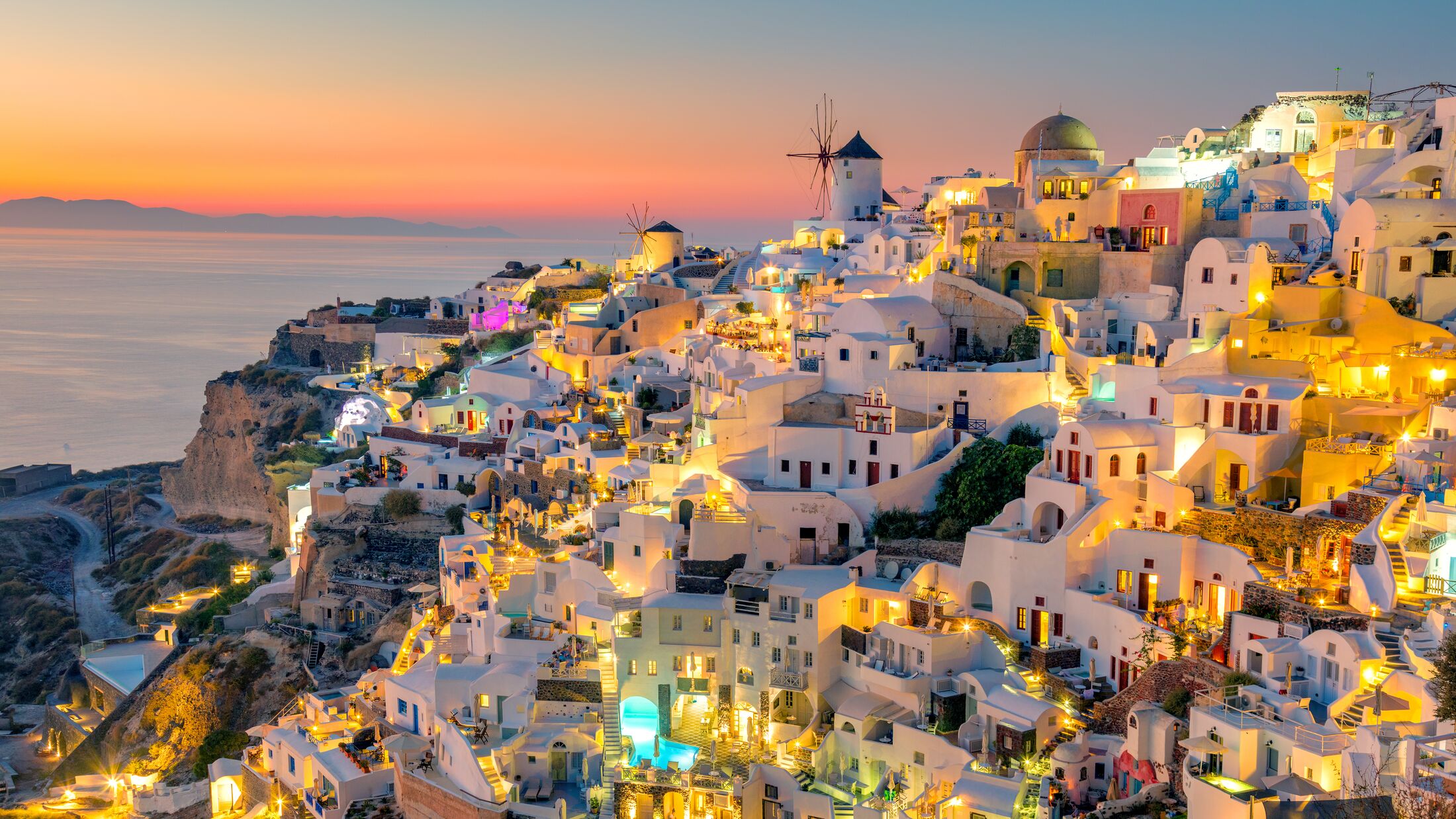 Sunset night view of traditional Greek village Oia on Santorini island in Greece. Santorini is iconic travel destination in Greece, famous of its sunsets and traditional white architecture