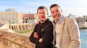 a man standing in front of a building