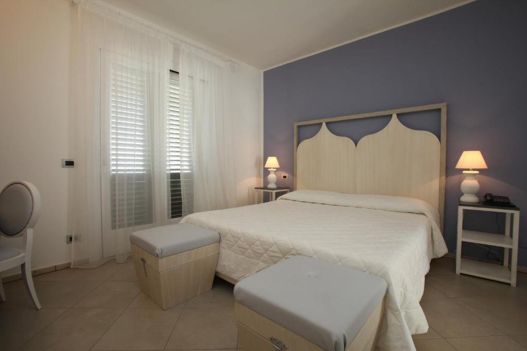 a bedroom with a large bed in a hotel room