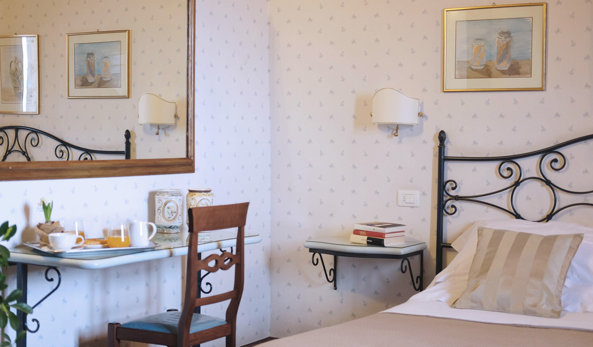 a bedroom with a bed and desk in a room