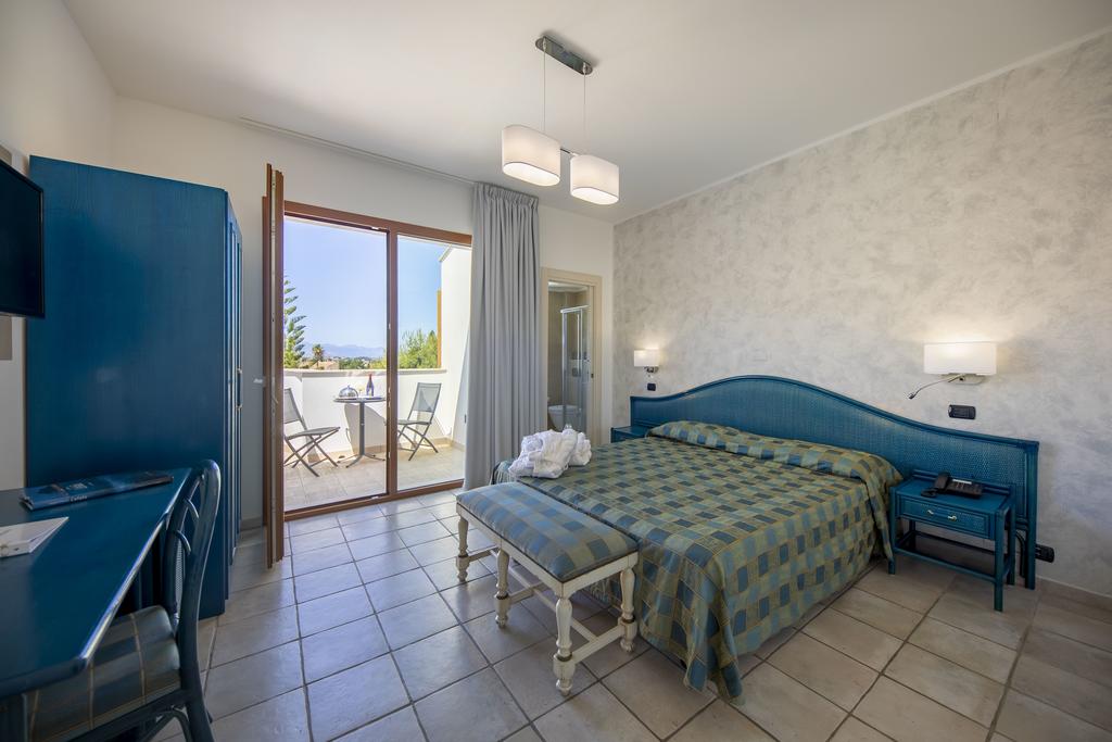 a bedroom with a bed and desk in a room