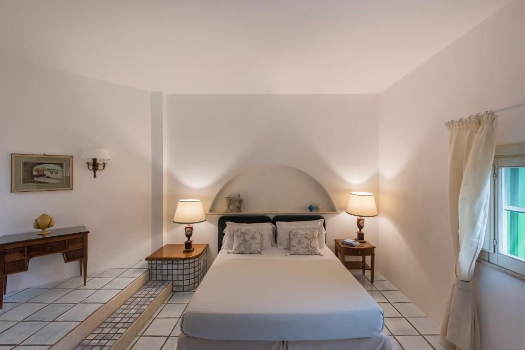a bedroom with a bed and desk in a small room