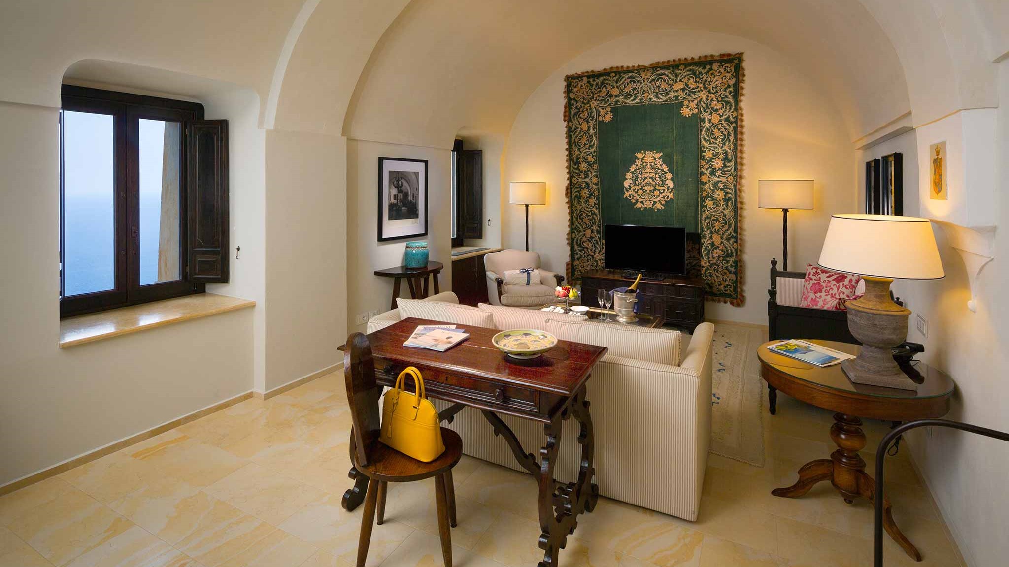 a living room filled with furniture and a large window