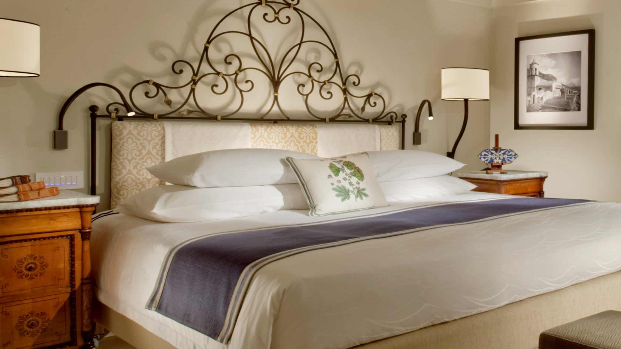 a bedroom with a bed and desk in a room