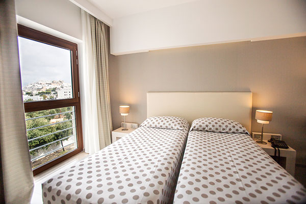 a bedroom with a bed and desk in a room