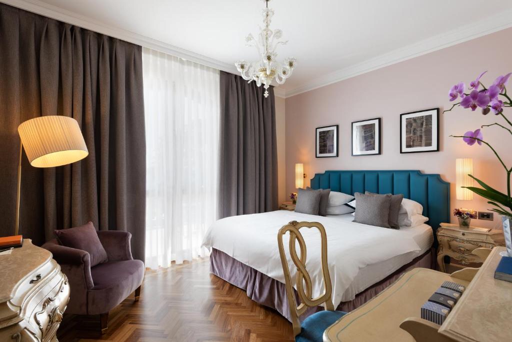 a hotel room filled with furniture and a flat screen tv