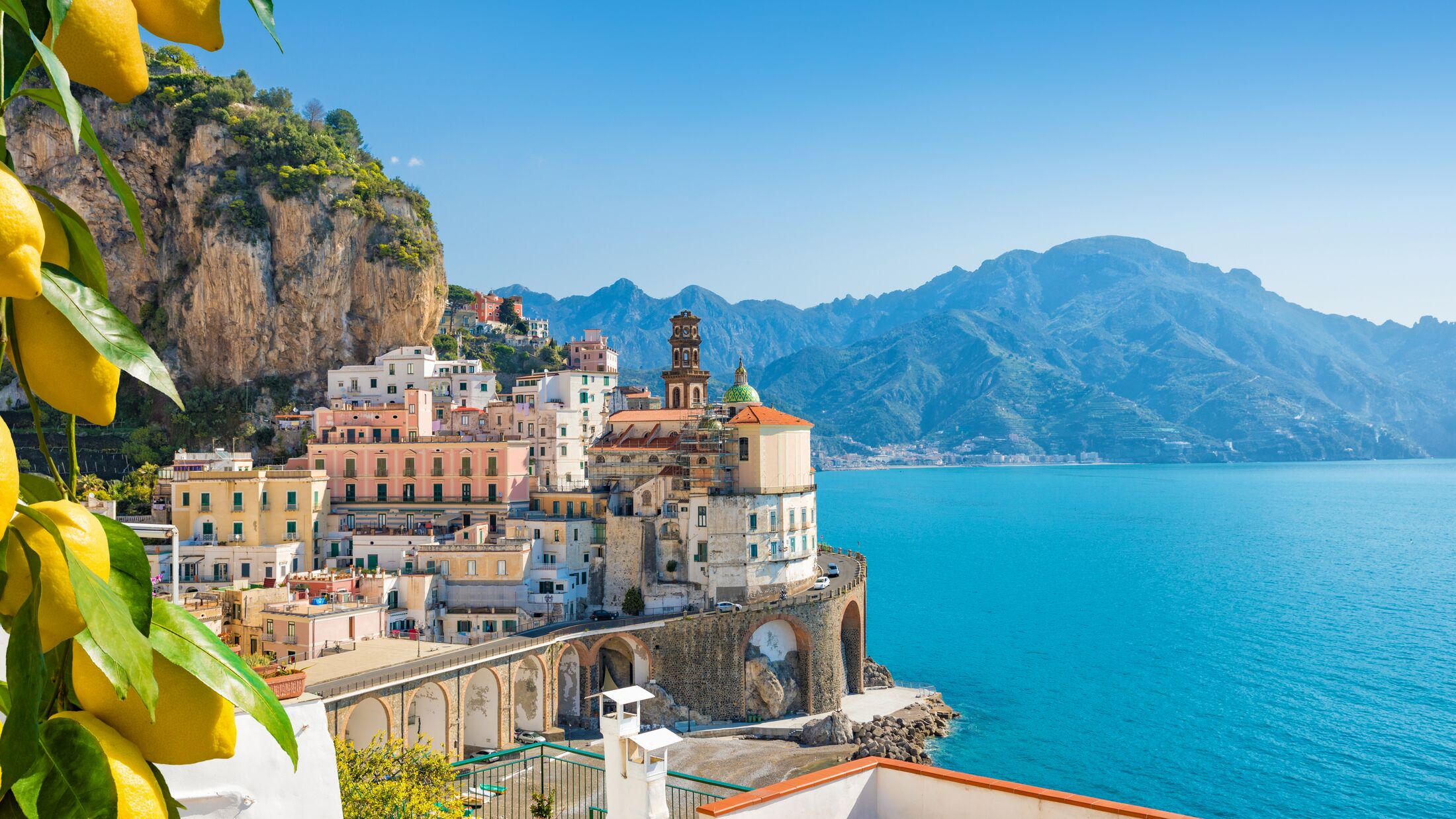 Small city Atrani on Amalfi Coast in province of Salerno, Campania region, Italy. Amalfi coast on Gulf of Salerno is popular travel and holyday destination in Italy. Ripe yellow lemons in foreground.