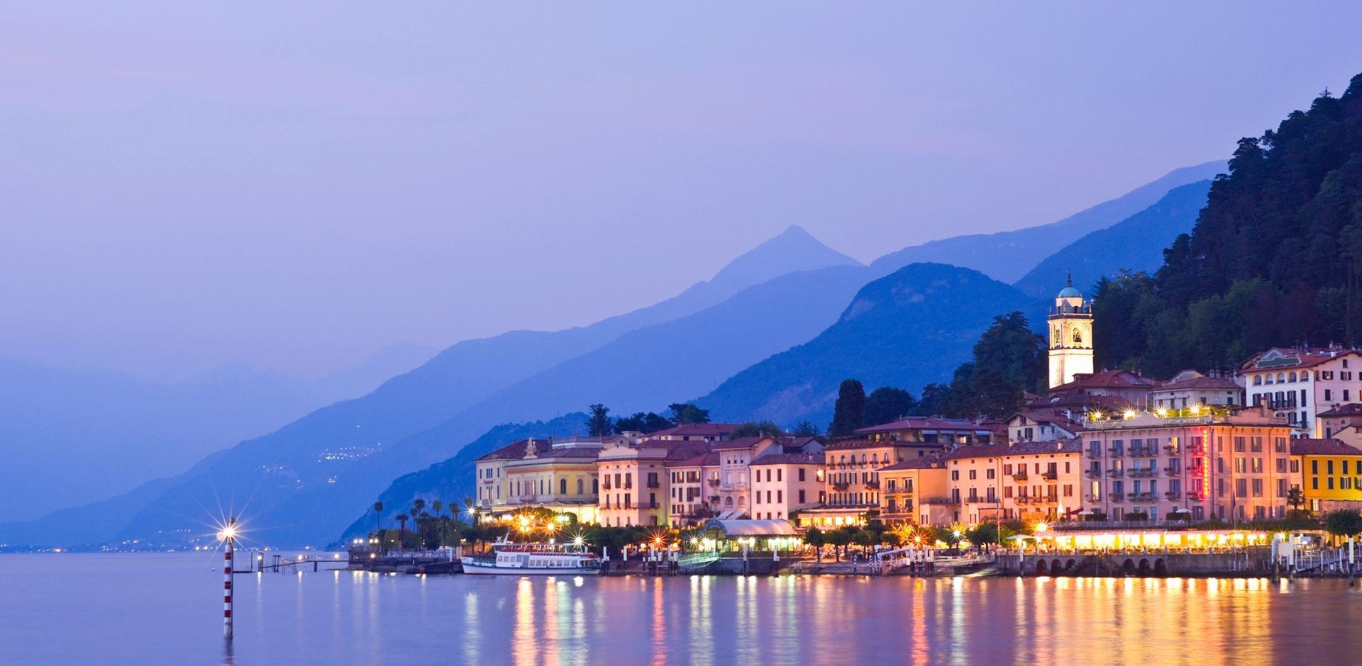 a large body of water with a mountain in the background