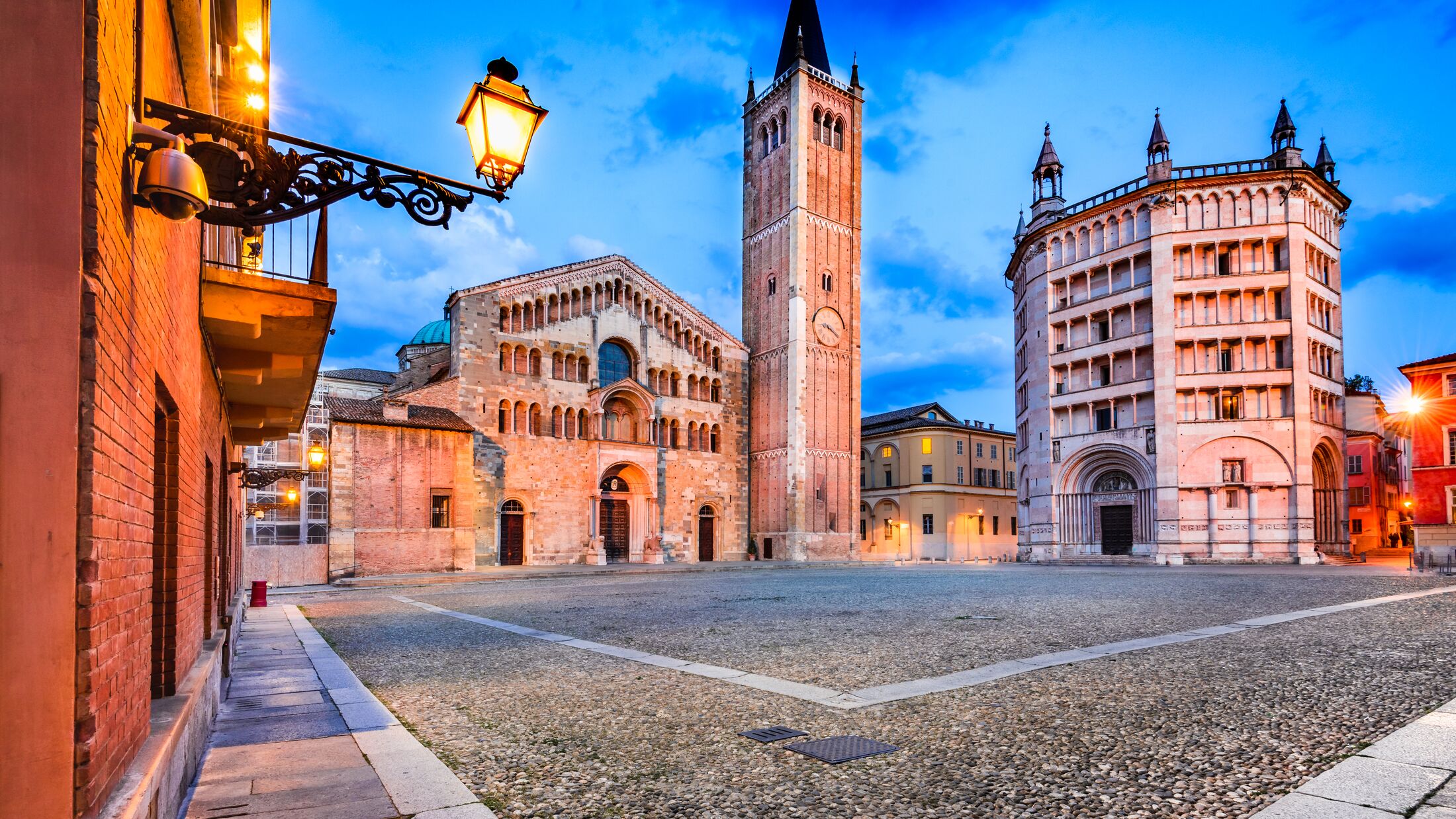Parma, Italy - Piazza del Duomo with the Cathedral and Baptistery, built in 1059. Romanesque architecture in Emilia-Romagna.