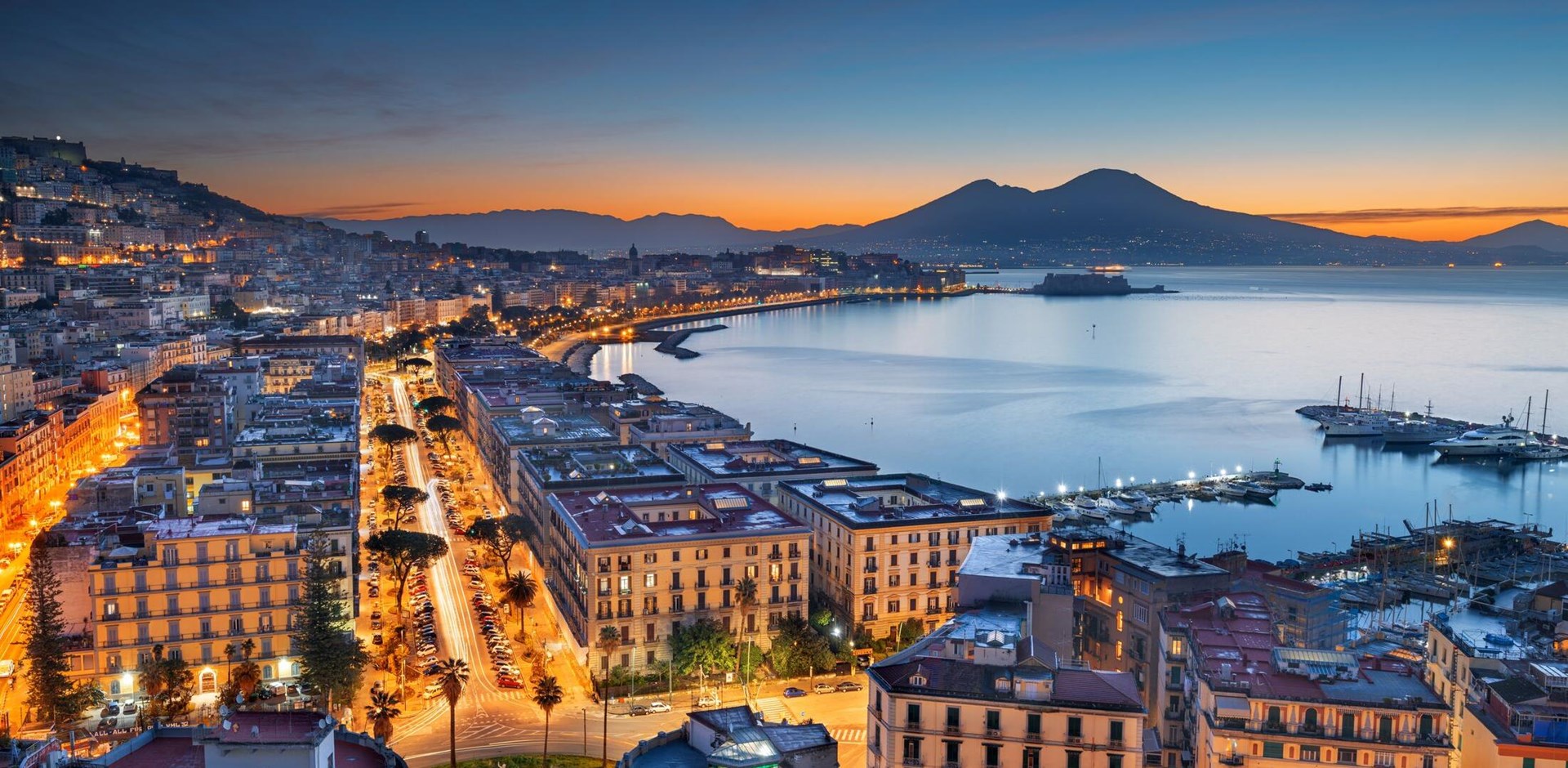 Naples, Italy aerial skyline on the bay with Mt. Vesuvius at dawn.