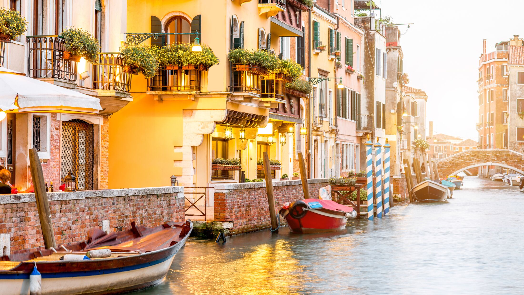 Small romantic water canal with restaurants in Dorsoduro region in Venice