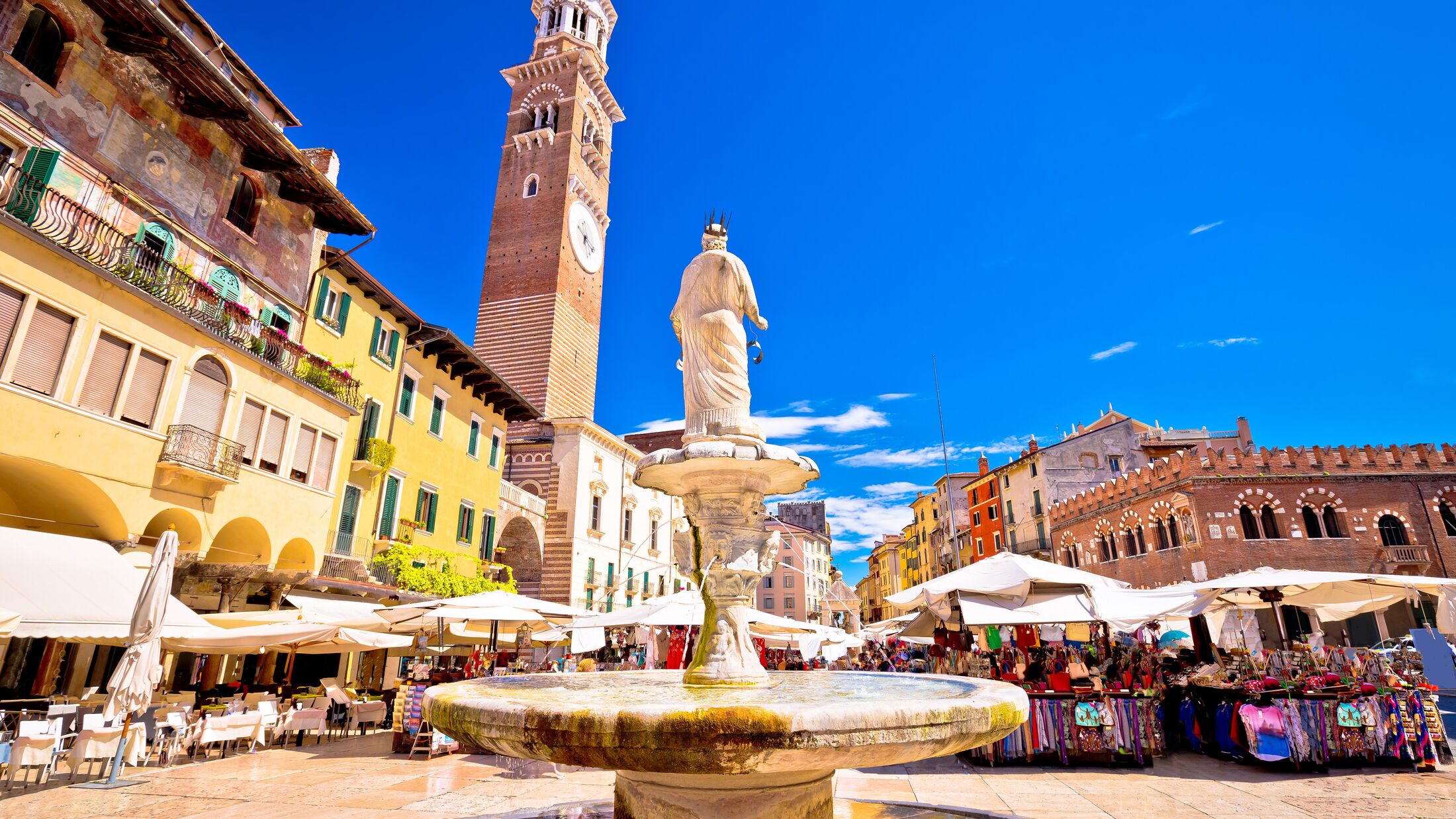 Piazza delle erbe in Verona street and market view with Lamberti tower, tourist destination in Veneto region of Italy