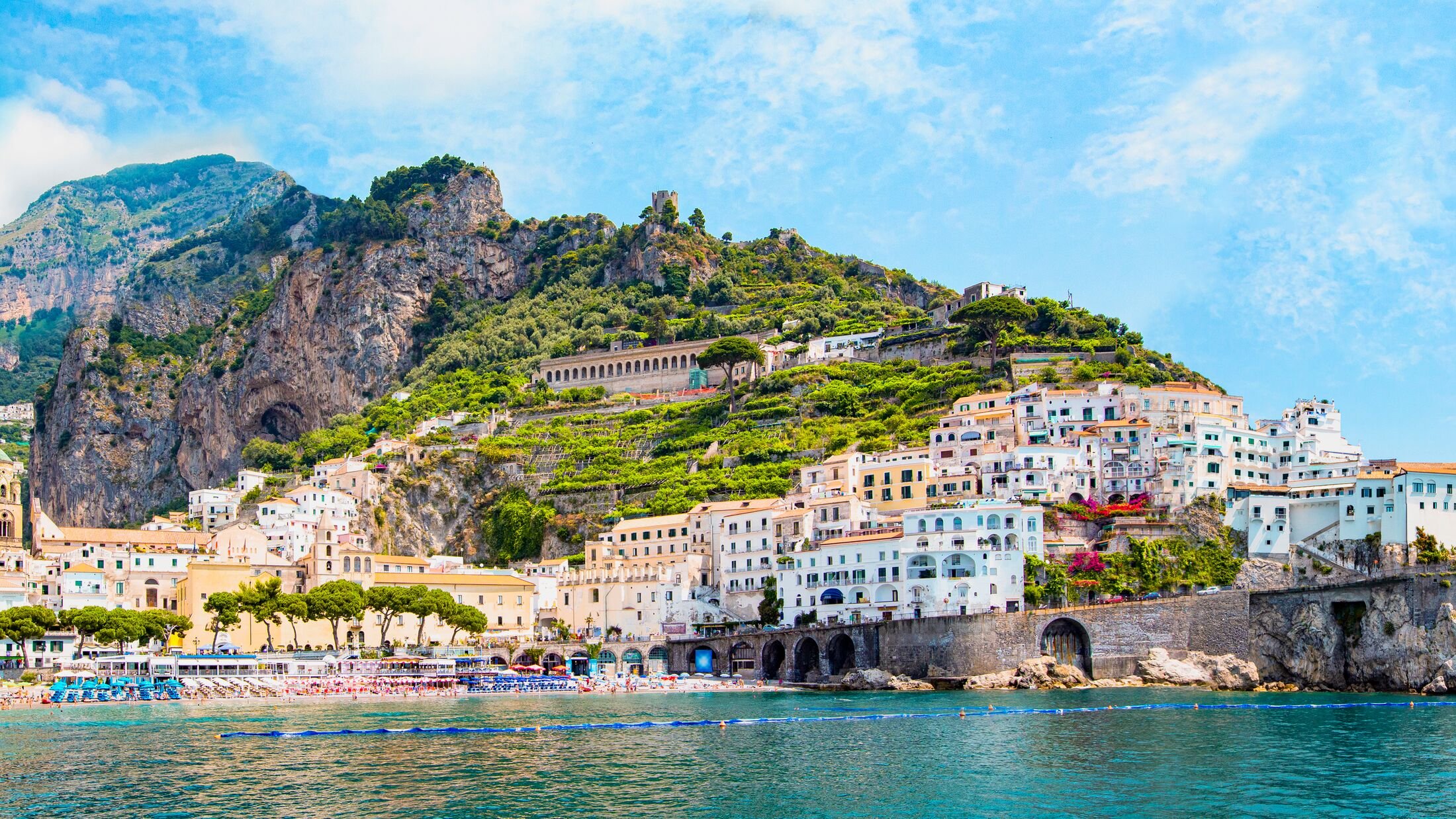 Panoramic view, aerial skyline of small haven of Amalfi village with tiny beach and colorful houses, located on rock, Amalfi coast, Salerno, Campania, Italy