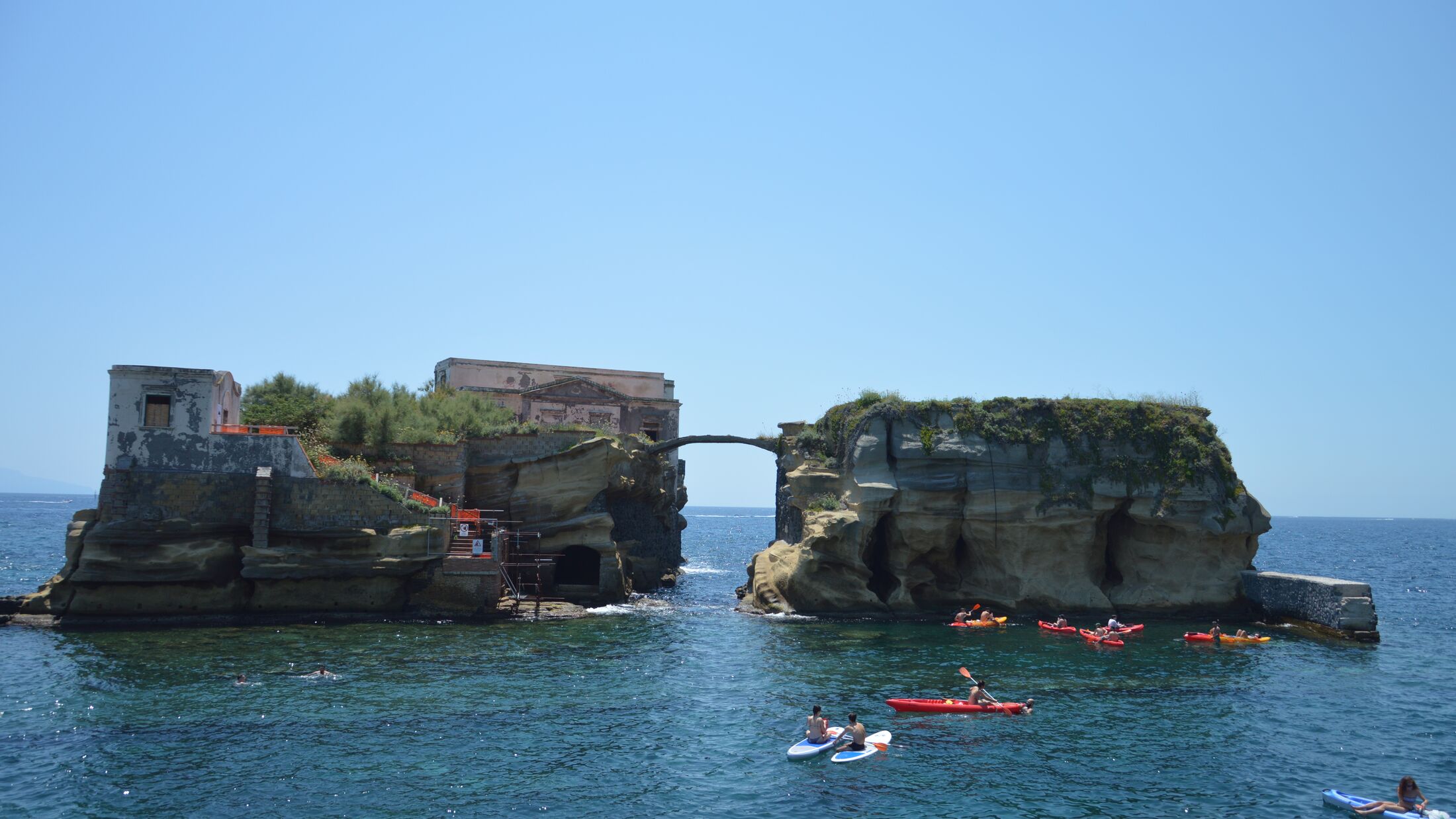 Sunbathers relax by the Gaiola Island, The Underwater Park of Gaiola, a protected marine area.Posillipo.Naples.Italy.