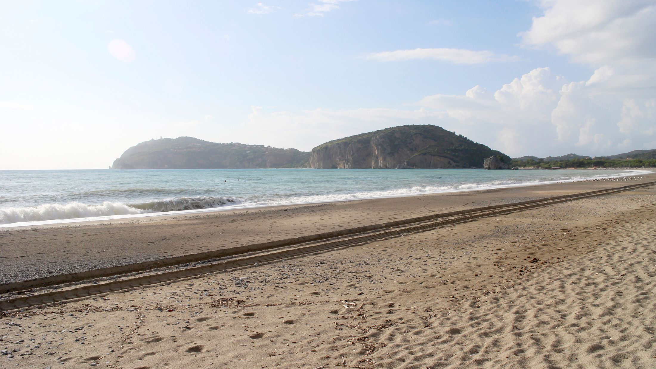 a sandy beach next to the water