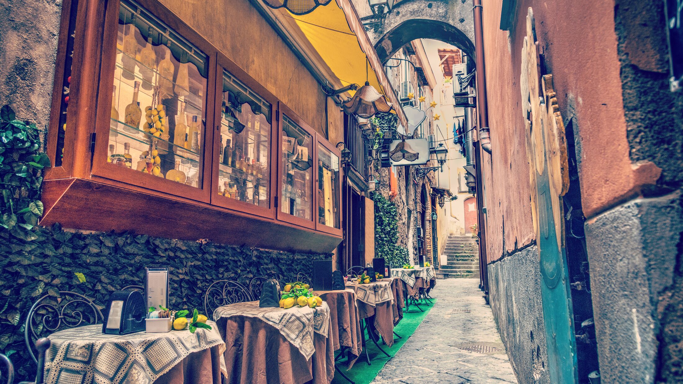 Rustic tables in a narrow alley in world famous Sorrento. Campania, Italy