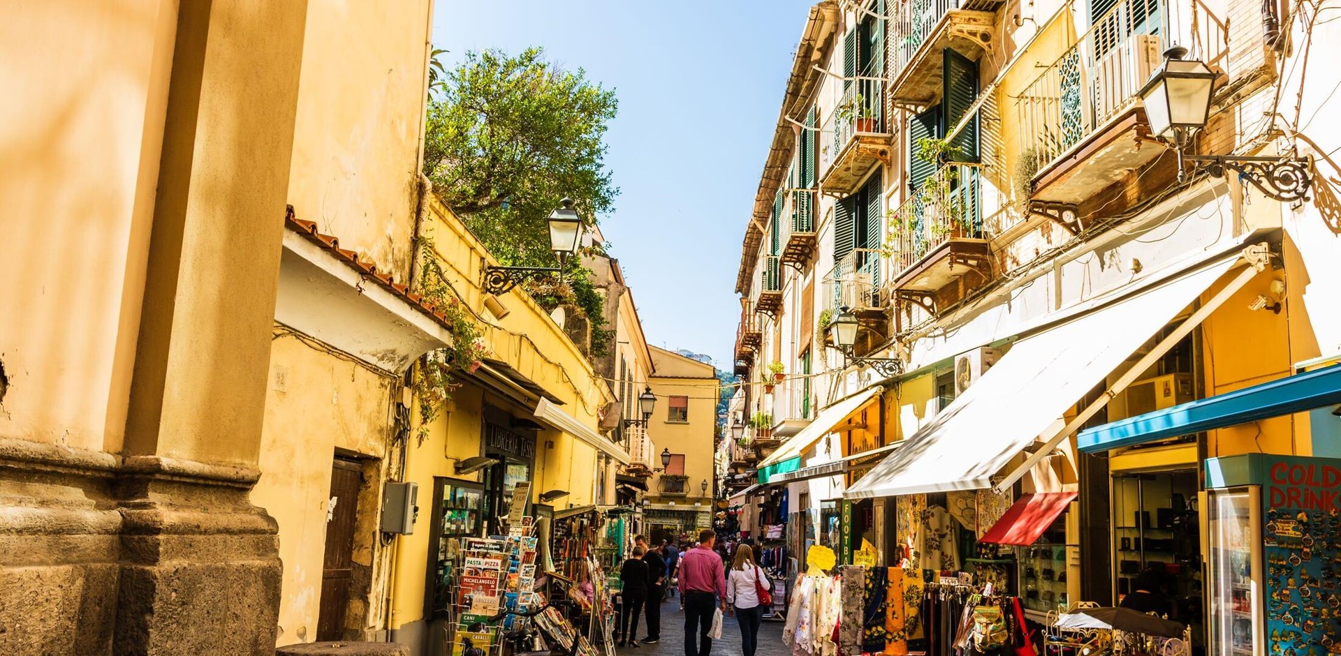 Couple walking on the narrow streets of Sorrento, Italy. Local shops in Sorrento.