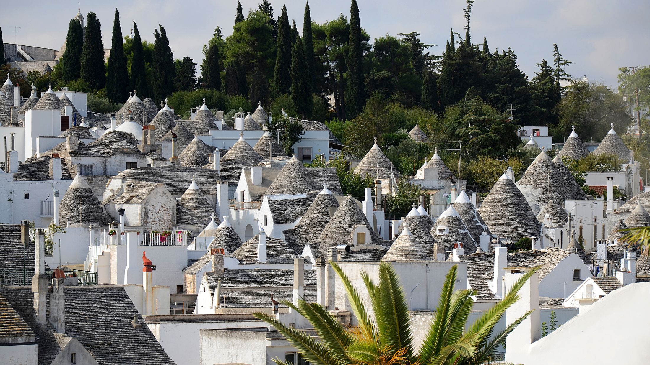 a group of people standing in front of Alberobello