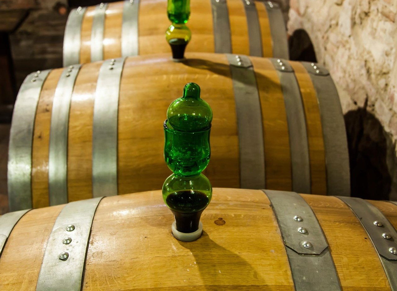 a bottle of wine sitting on top of a wooden table