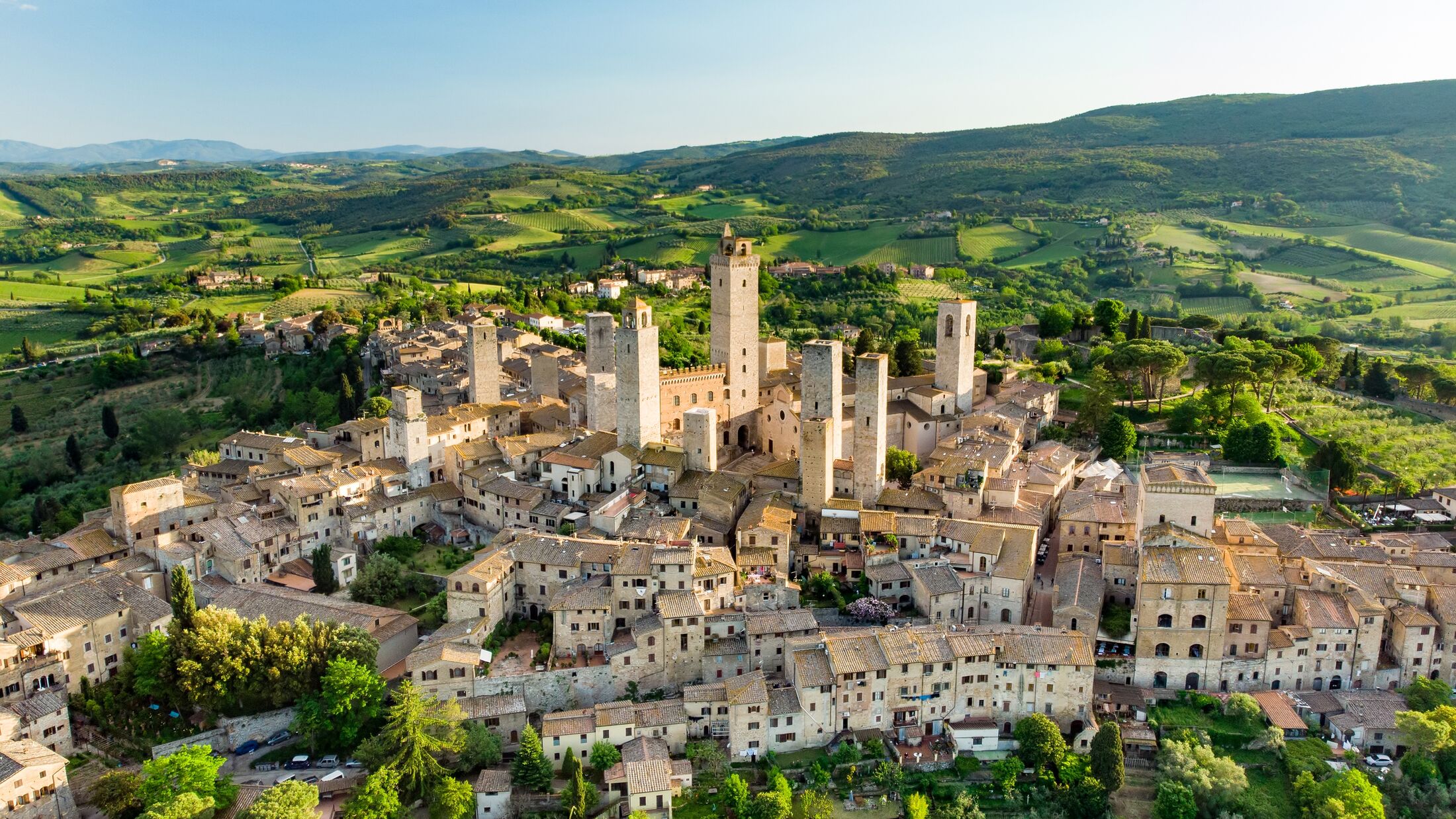 Aerial view of famous medieval San Gimignano hill town with its skyline of medieval towers, including the stone Torre Grossa. UNESCO World Heritage Site. Province of Siena, Tuscany, Italy.
