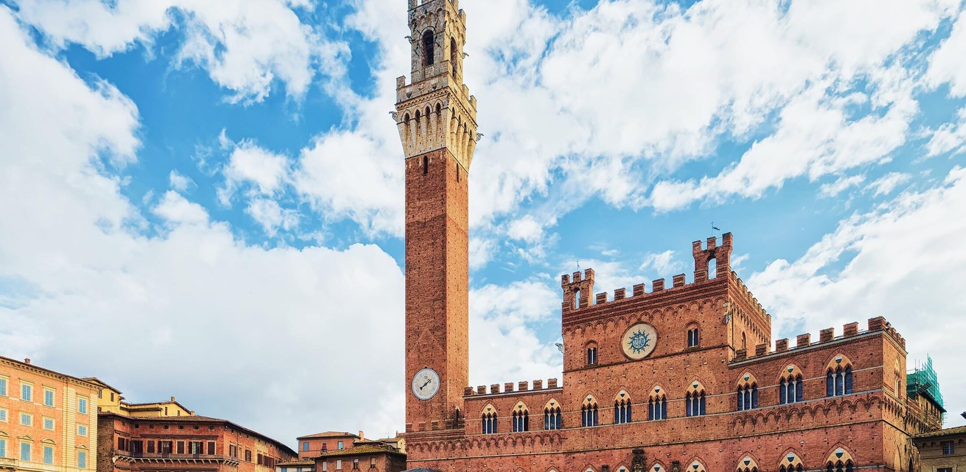 People at Torre del Magnia Tower on Piazza Campo Square in Siena, Tuscany, Italy