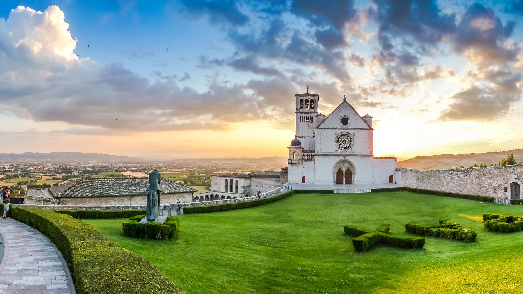 Famous Basilica of St. Francis of Assisi (Basilica Papale di San Francesco) at sunset in Assisi, Umbria, Italy