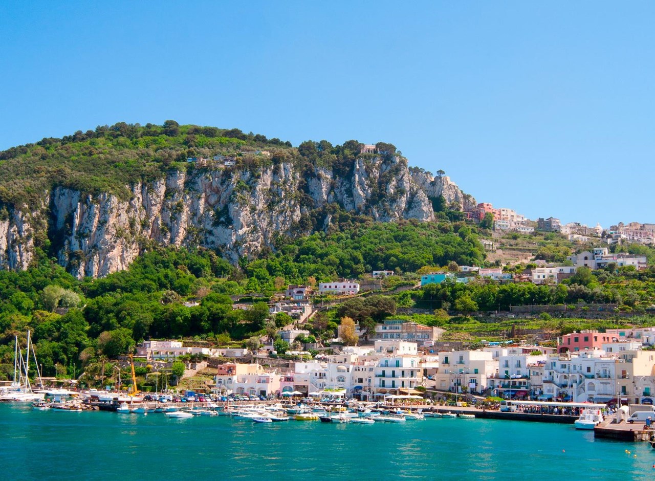 a large body of water with a city in the background