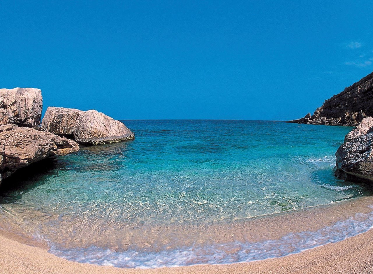 a rocky beach next to the ocean