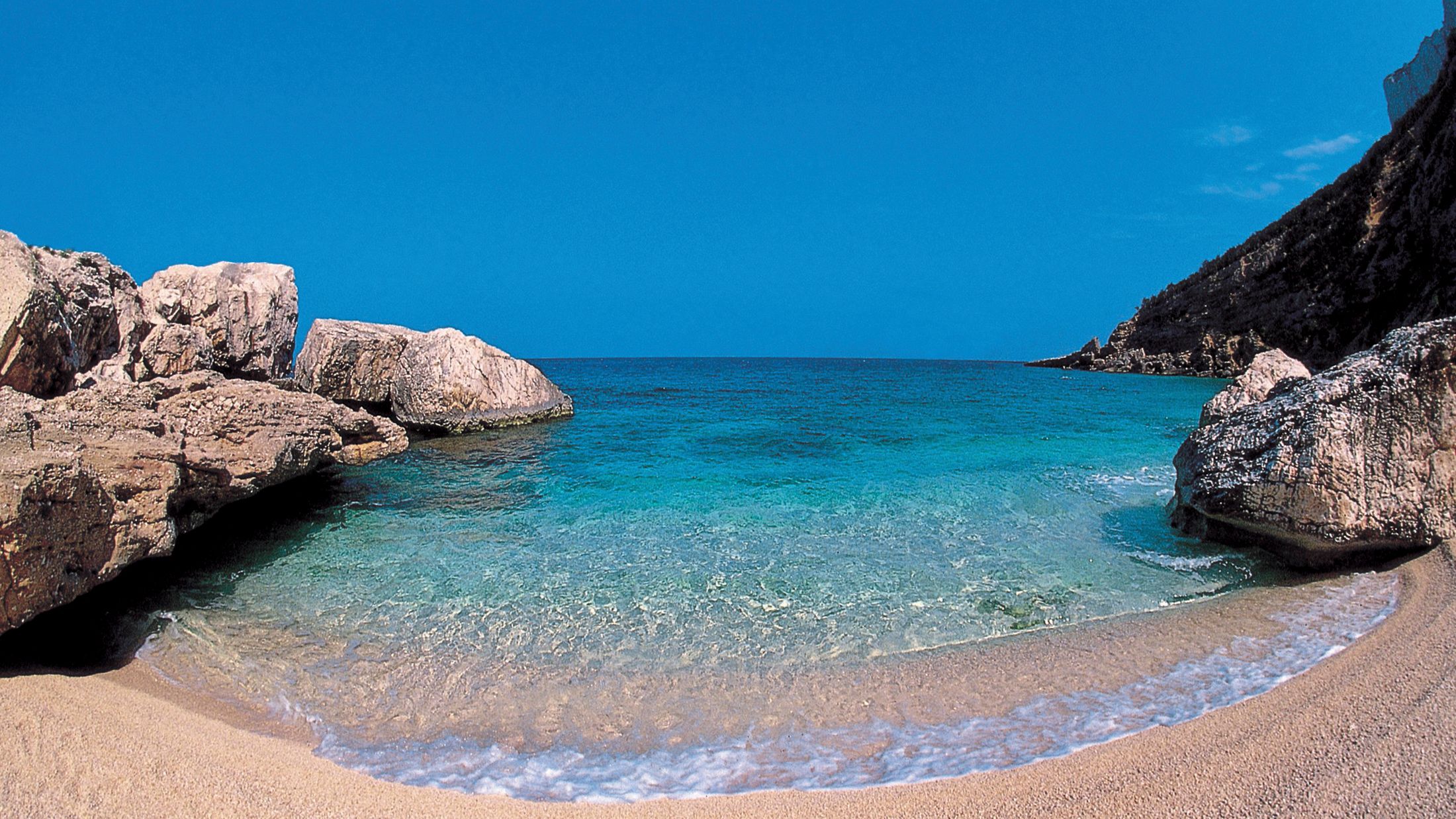 a rocky beach next to the ocean