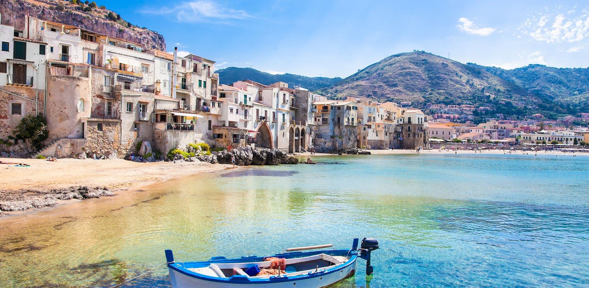 Beautiful old harbor with wooden fishing boat in Cefalu, Sicily, Italy.