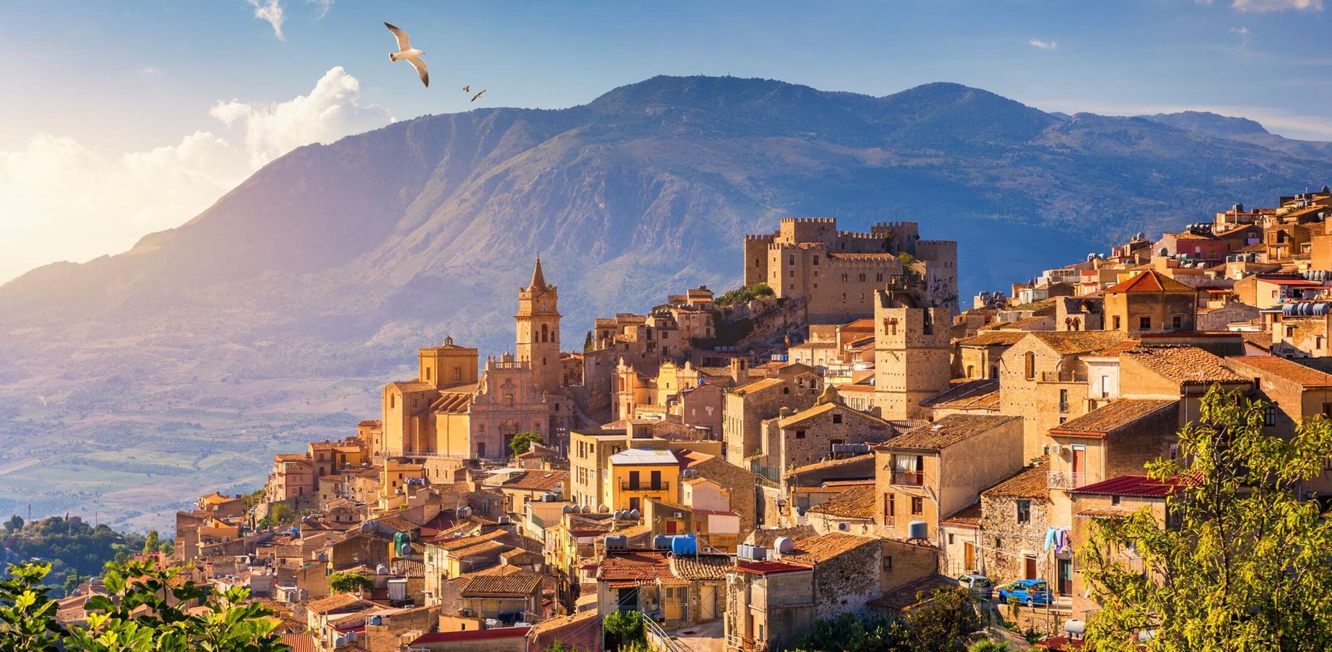 Caccamo, Sicily. Medieval Italian city with the Norman Castle in Sicily mountains, Italy. View of Caccamo town on the hill with mountains in the background, Sicily, Italy.